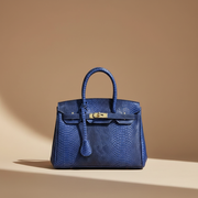 Héritage, sac rétro en cuir de vachette grain reptile, coloris Bleu
